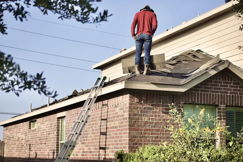 Professional roofer working on a residential roof in Dominguez Junction